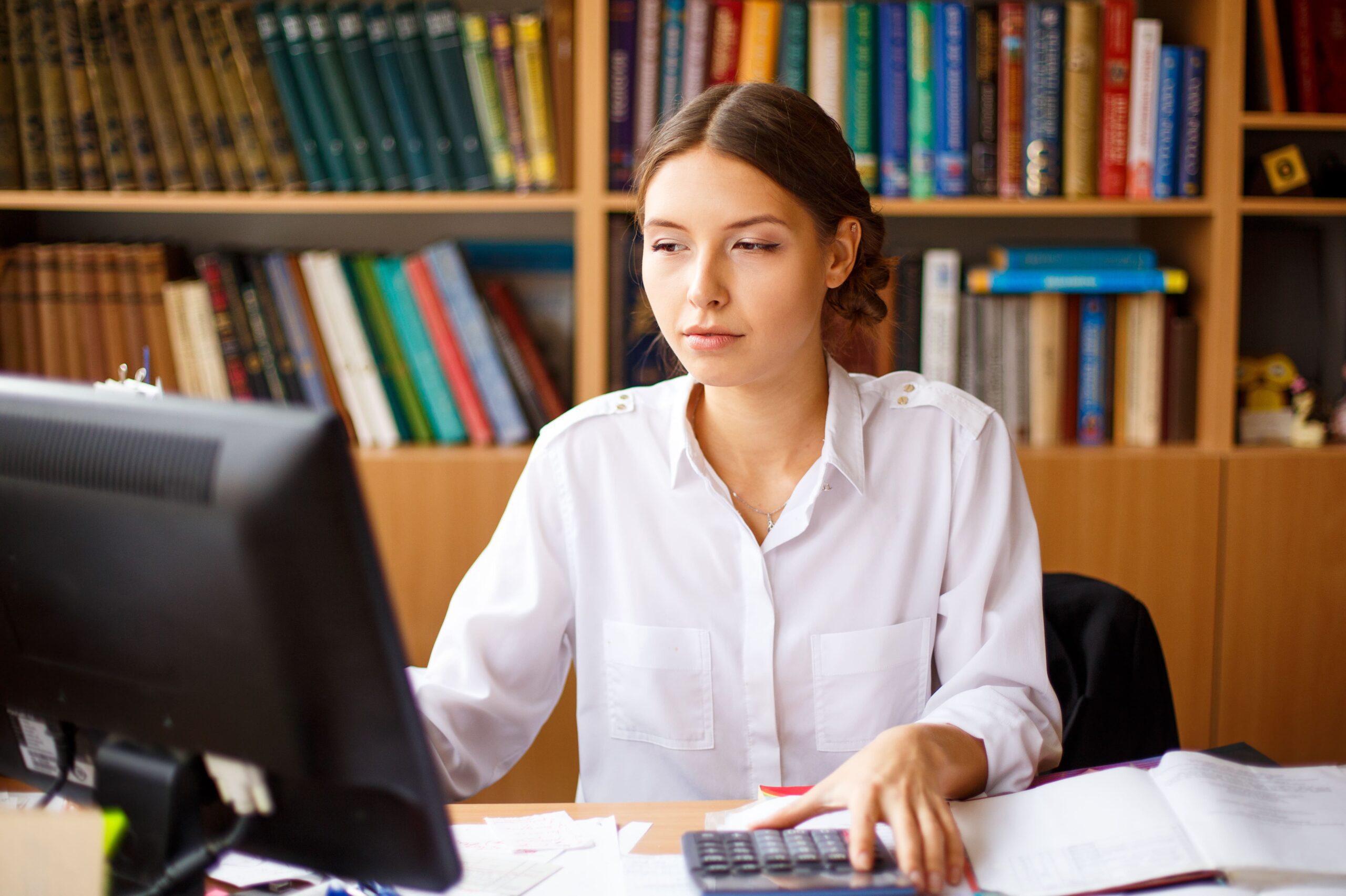 female administrative assistant checking computer