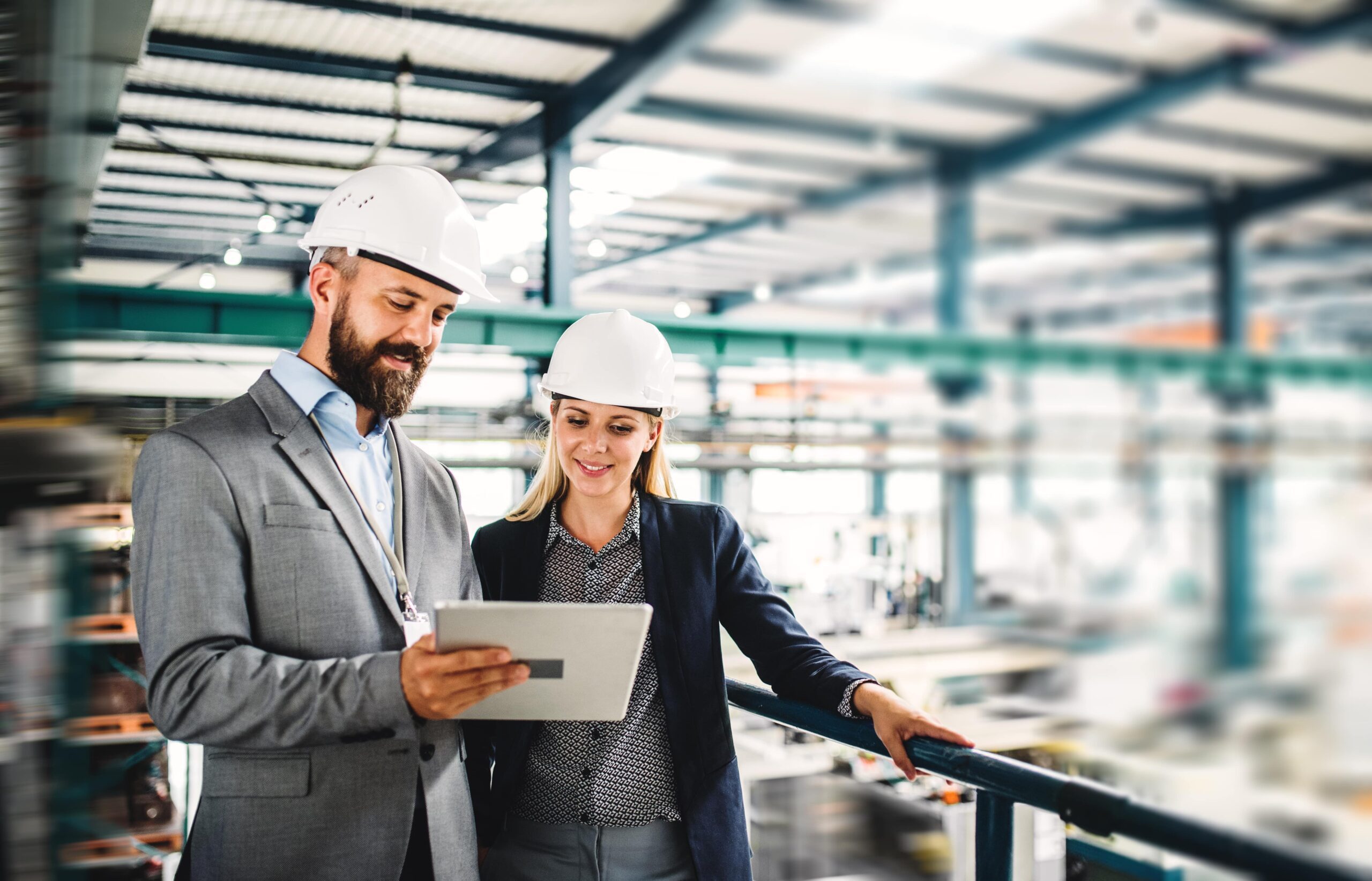 industrial man and woman engineer with tablet in a factory, working.